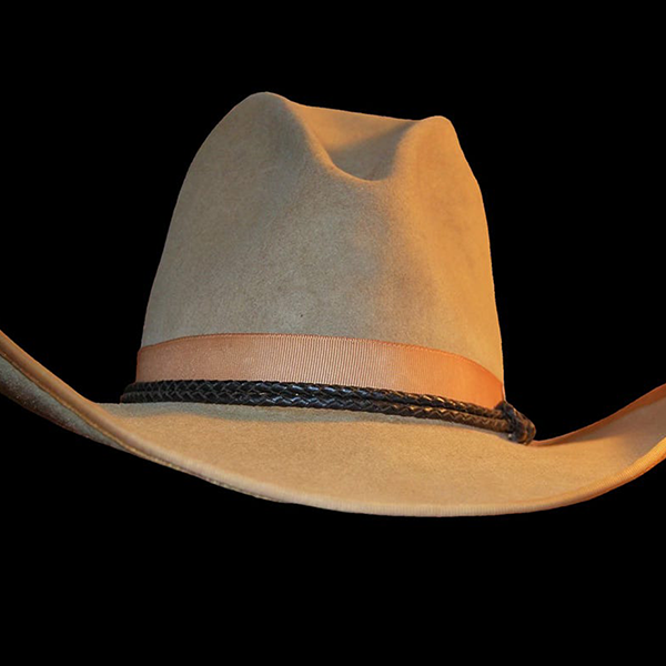 A cowboys hat on a black background.